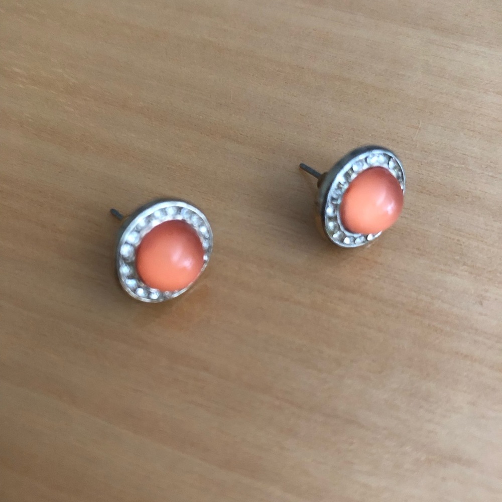 Peach pierced earrings, surrounded by rhinestones
